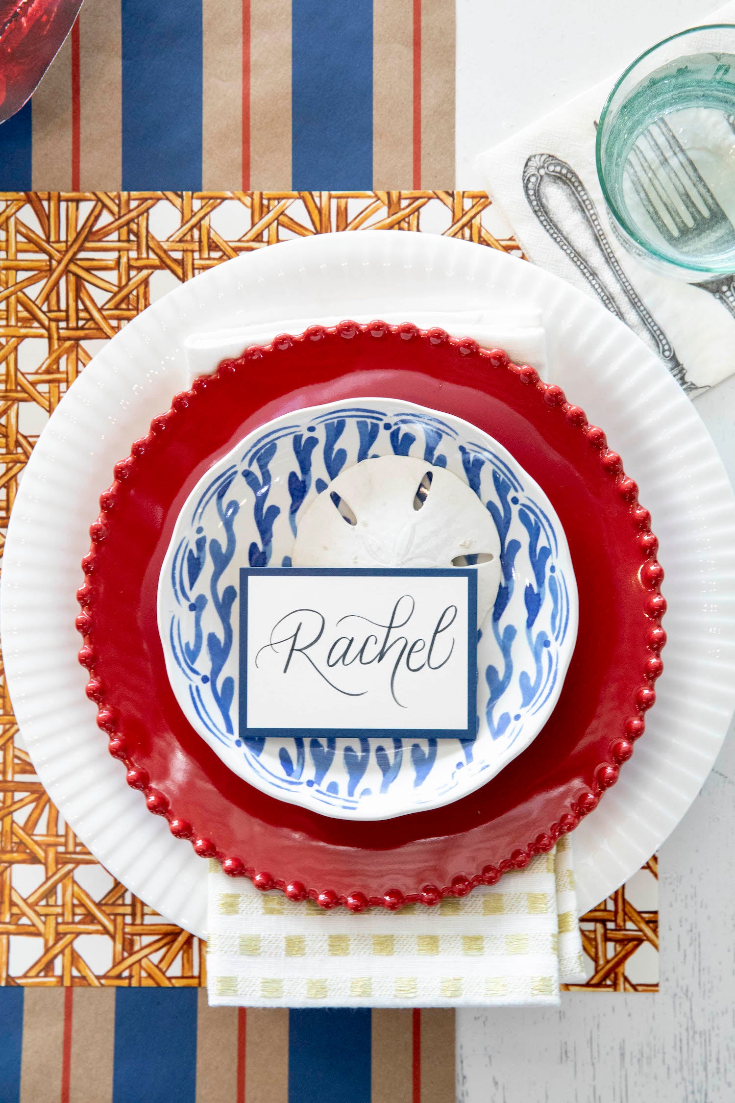 A table setting with the Hester &amp; Cook Kraft Navy &amp; Red Awning Stripe Runner and plates and napkins perfect for entertaining.