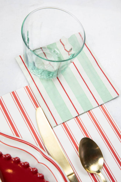 A Seafoam &amp; Red Awning Stripe Napkins placemat with a spoon and fork, perfect for a table setting. Hester &amp; Cook