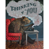 A bear seated on a red chair using an old-fashioned rotary phone, with a thought bubble reading "thinking of you" above it. This image is featured on an original artwork Thinking of You card by Hester & Cook.