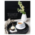 A photo of a round black tray with a cup of coffee and a cupcake with a lit candle, sitting on a white table with a white vase of flowers on a black background, with "{Write it on your heart that everyday is the best day in the year.} Ralph Waldo Emerson" printed in white.