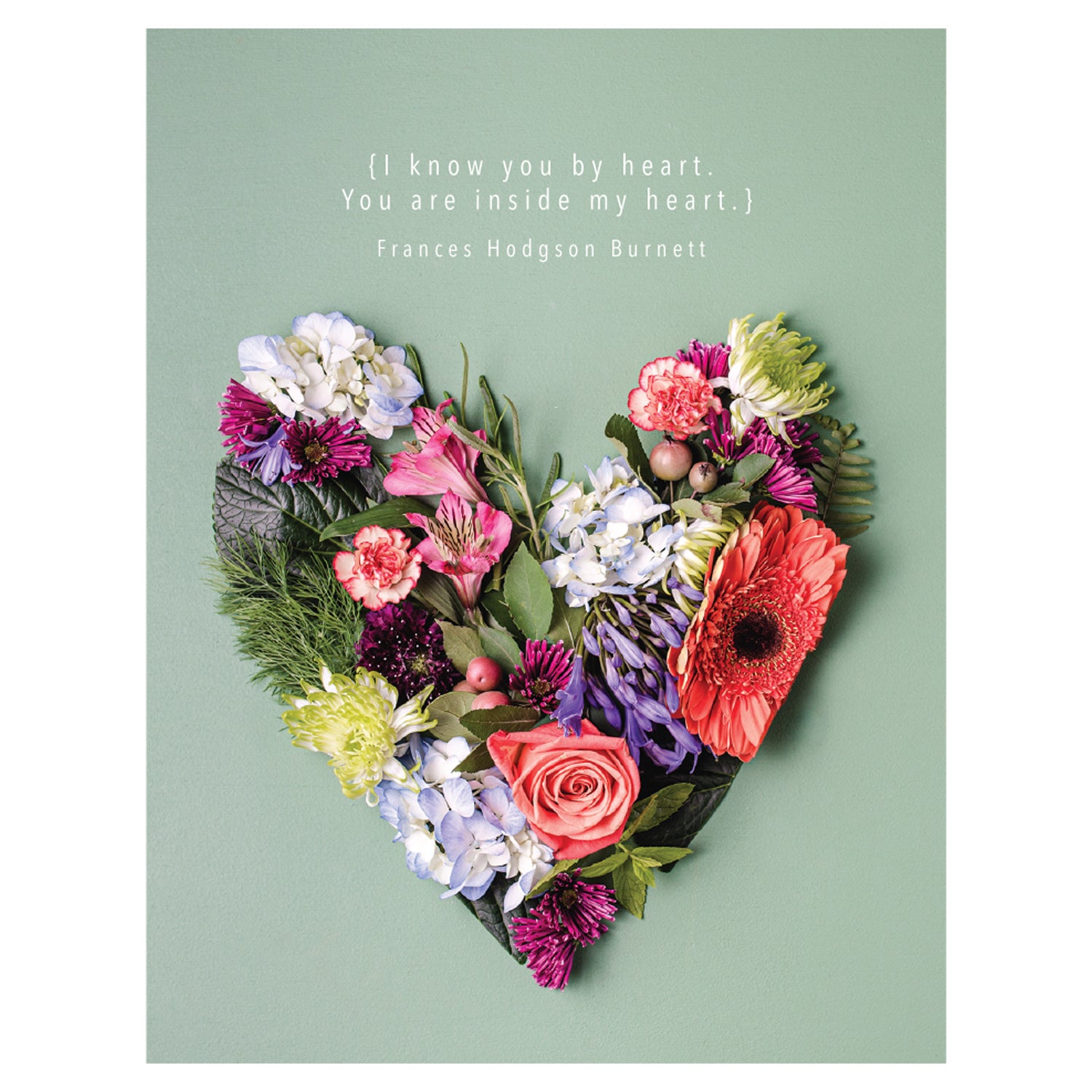 A Know You by Heart greeting card from Hester &amp; Cook featuring a heart-shaped arrangement of various colorful flowers, captured in original photography, on a green background with a romantic quote by Frances Hodgson Burnett at the top, printed on high quality uncoated stock.