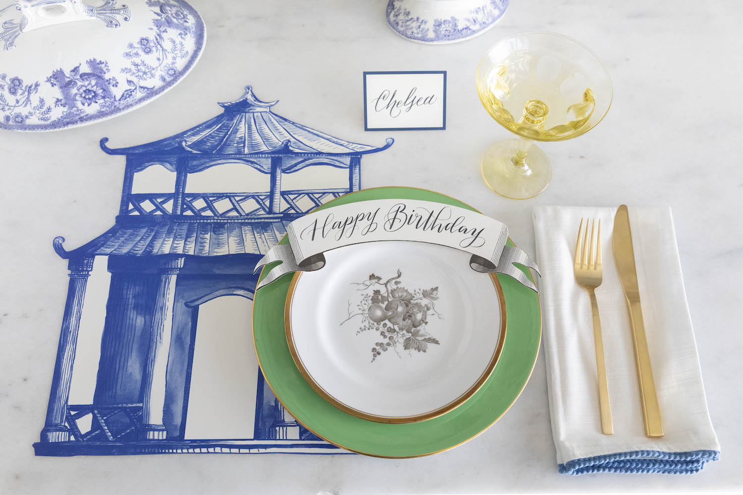 An elegant blue and white tablescape with a Die-cut Pagoda Placemat by Hester &amp; Cook.