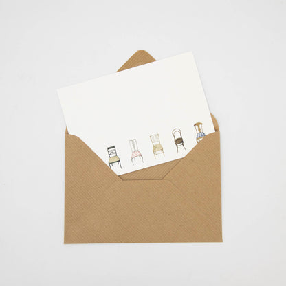 A brown envelope with a drawing of Musical Chairs Flat Notes on it, perfect for sending flat notes from Hester &amp; Cook.
