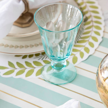 The Seafoam &amp; Gold Awning Stripe Runner under an elegant place setting.