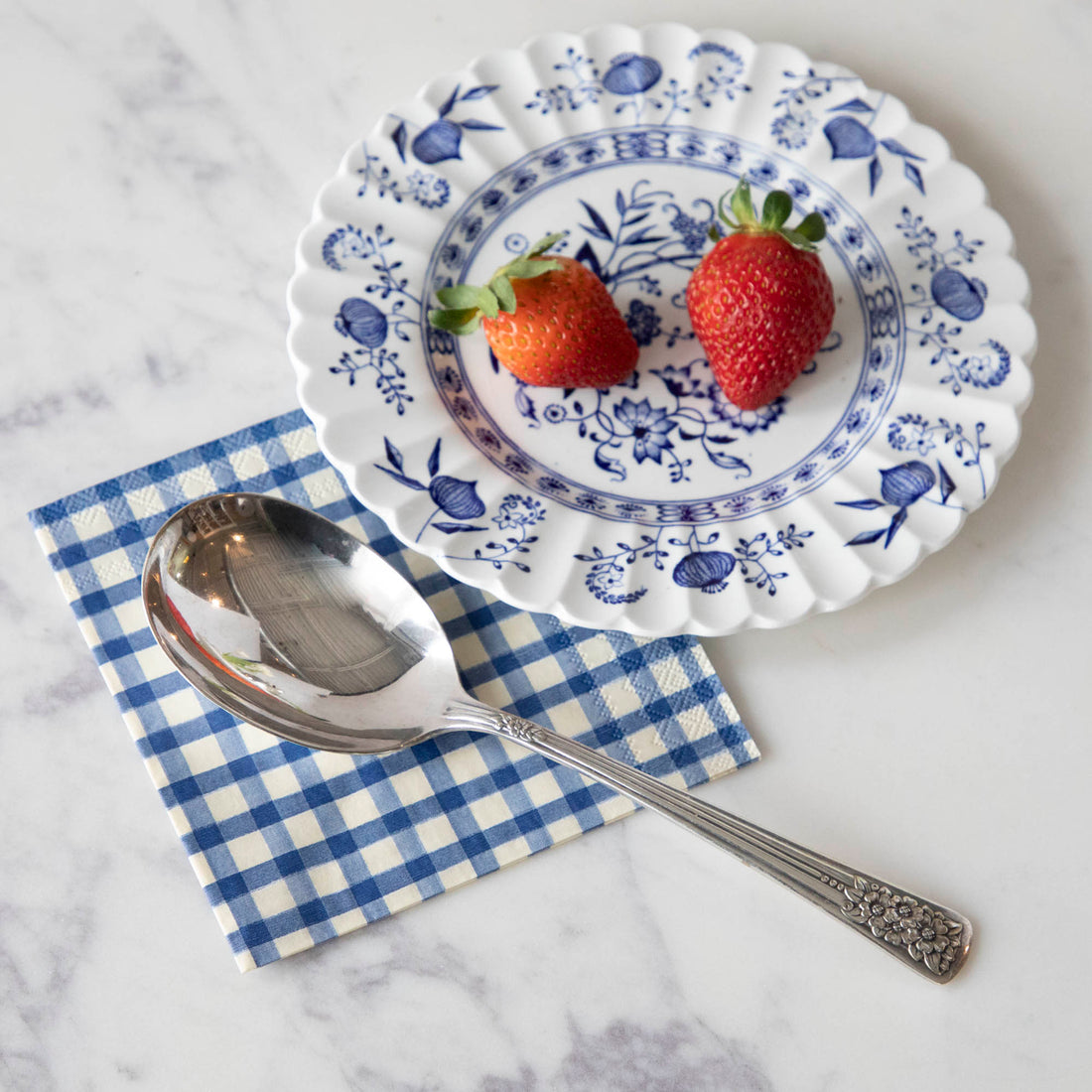 A Hester &amp; Cook vintage silver-plate berry spoon with summer fruits.