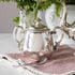 A Hester & Cook vintage silver-plate sugar bowl on a pink tablecloth.