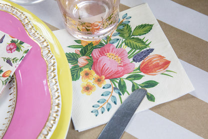 A table setting with florals, Sweet Garden Napkins, and utensils perfect for garden parties.
