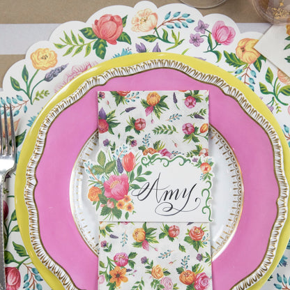 A pink and yellow place setting with Die-cut Sweet Garden Posey placemats from Hester &amp; Cook.