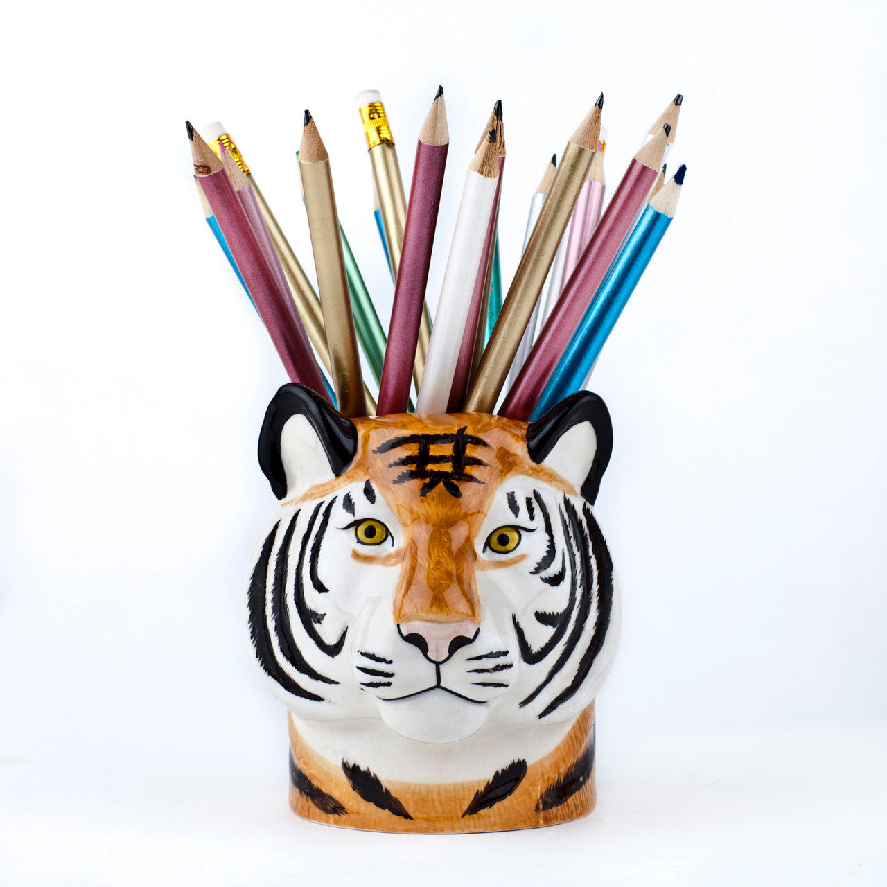 A quirky Tiger Ceramic pencil holder filled with a vibrant set of colored pencils designed by British brand, Quail.