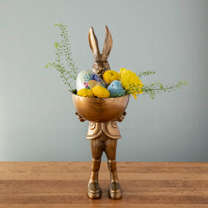 A well-dressed Hare Dishstand by Accent Decor holding a round dish of eggs on a wooden table.