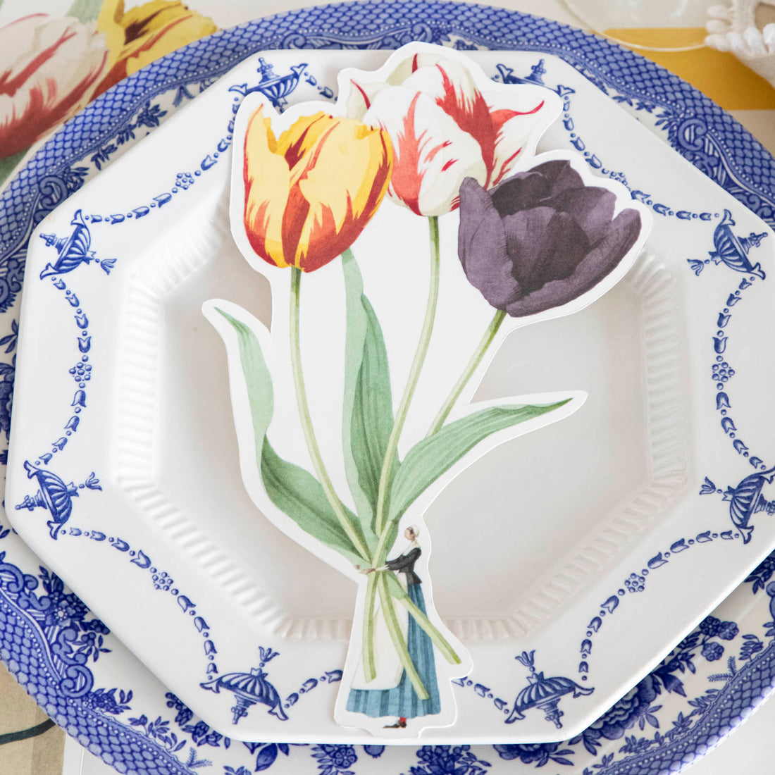 Close-up of a Tulips Table Accent resting on the plate of an elegant place setting.