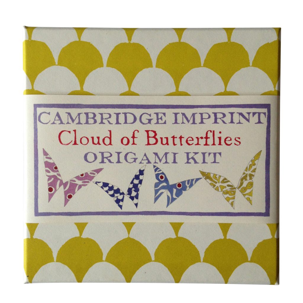 Origami Cloud of Butterflies Kit with instructions and Cambridge Imprint patterned paper on a wooden table.