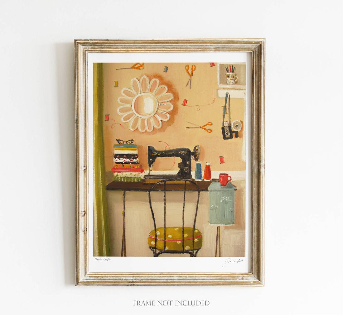 A framed Hipster Crafter Small Art Print by Janet Hill of a vintage sewing machine and various sewing accessories on a table.