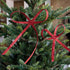  An 8" and 12" red Glitter Flakes Bow, clipped to a tree.