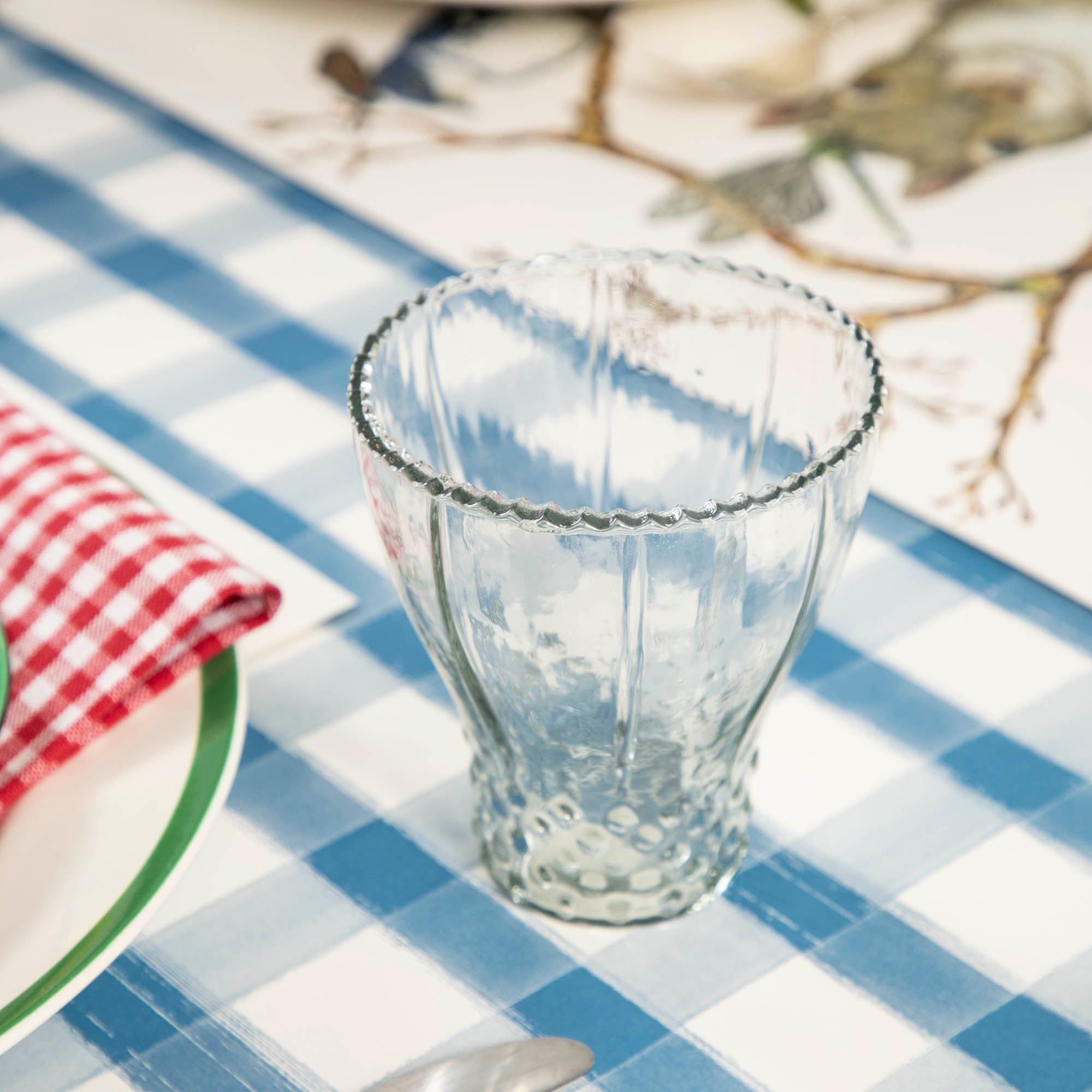 A blue and white checkered tablecloth with Be Home&