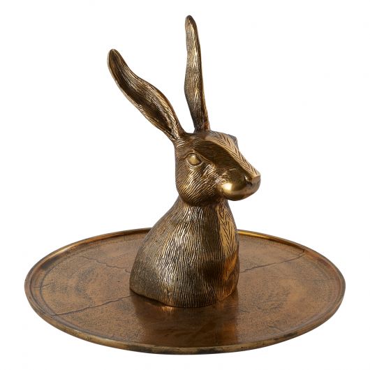 A whimsical brass Accent Decor hare head on a bronze Accent Decor platter.