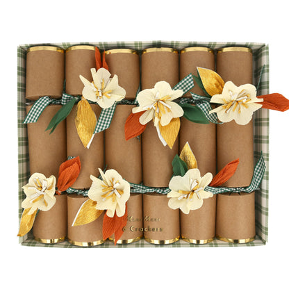 Brown paper cracker embellished with handmade crepe paper flowers and leaves, have gold foil borders and gorgeous green gingham ribbon ties