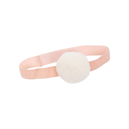 A white pom pom on a pink ribbon, perfect for a Meri Meri Peach Tulle Bunny Costume.