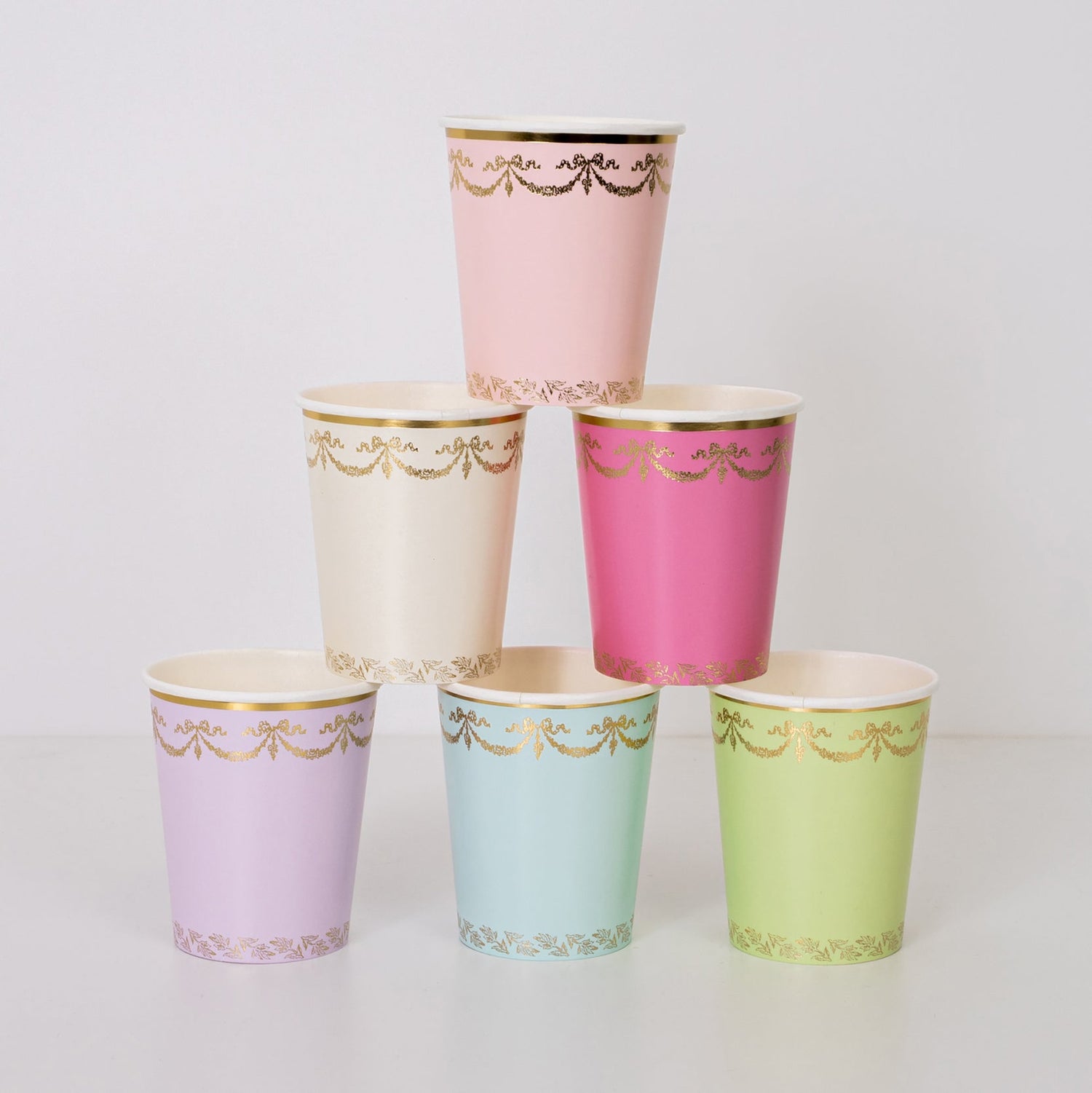 A stack of colorful Meri Meri Ladurée Paris Cups with gold trim.
