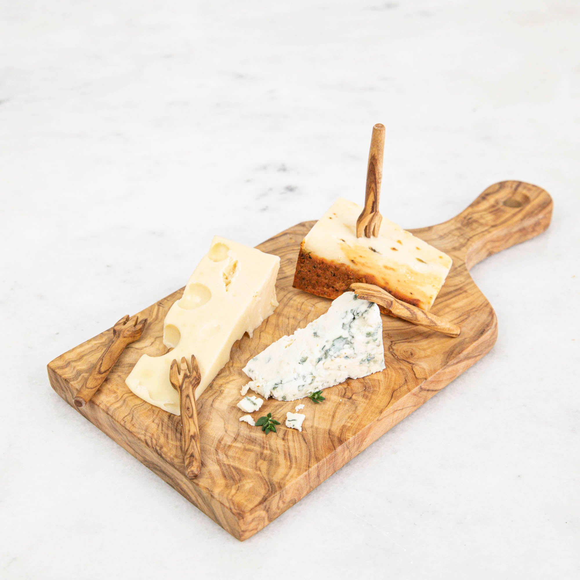 A Natural Olivewood Cheese Board with cheese on it, perfect for serving hors d&