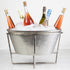 Five bottles of sparkling wine chilling in an ice-cold, Bidk Home Extra Large Nickel Party Bucket on Stand.