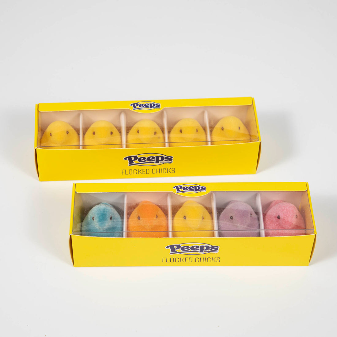 A boxed set of Glitterville Small Flocked PEEPS® Boxed Set of 5, which includes four different colored marshmallow candies shaped like eggs.