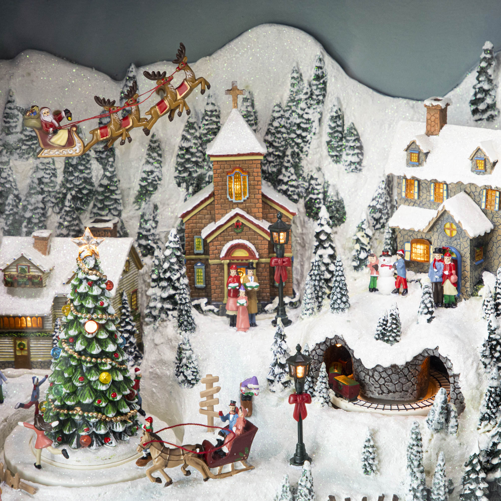 A close up of the Retro Animated TV scene showing a winter village with Christmas festivities and Santa and his reindeer flying above the town.