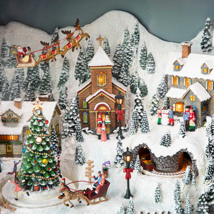 A close up of the Retro Animated TV scene showing a winter village with Christmas festivities and Santa and his reindeer flying above the town.