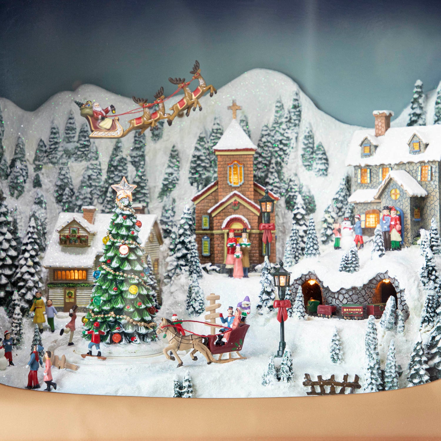 A close up of the Retro Animated TV scene showing a winter village with Christmas festivities and Santa and his reindeer flying above the town.