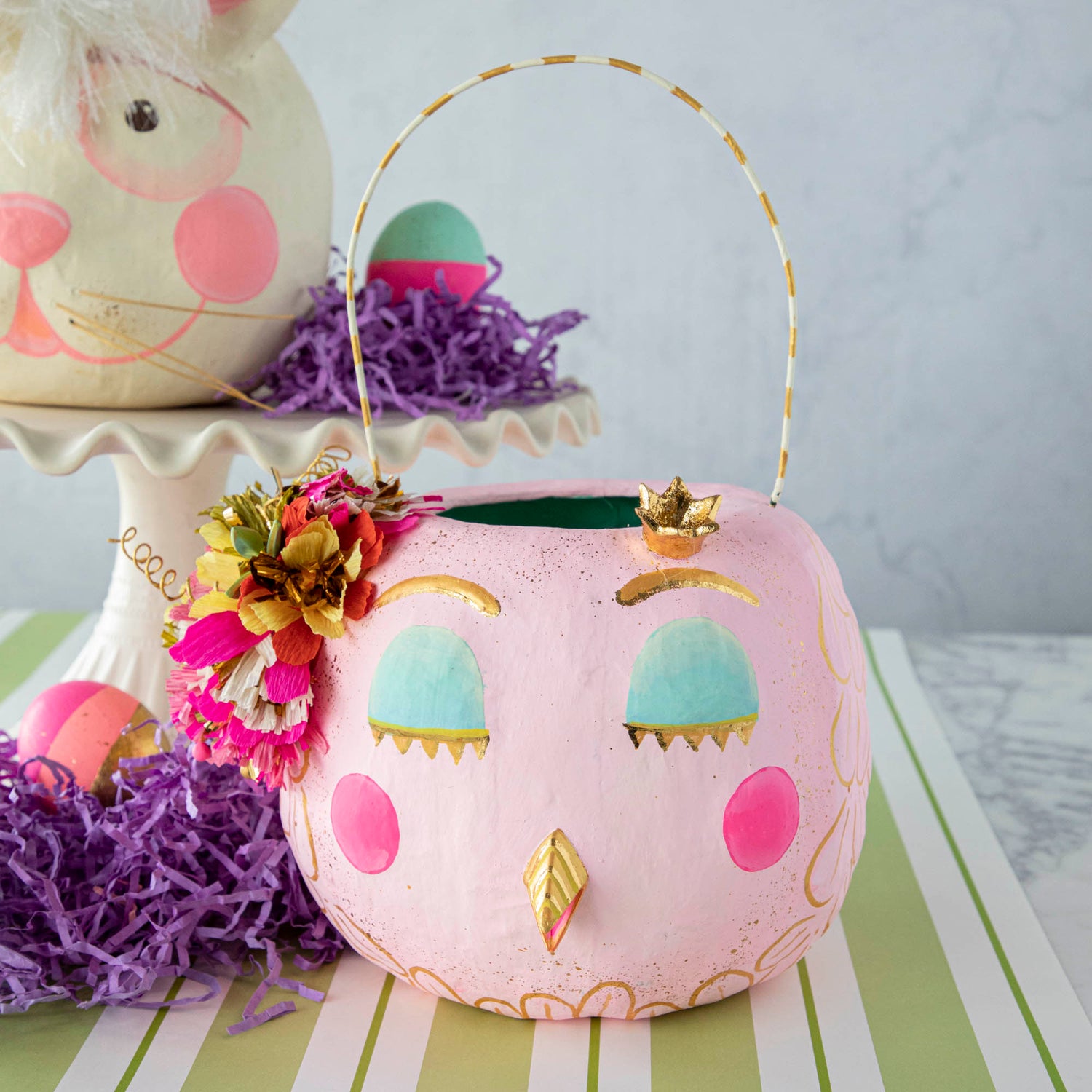 A festive pink Glitterville Papermache Easter Bucket adorned with a cute owl and bunny design.