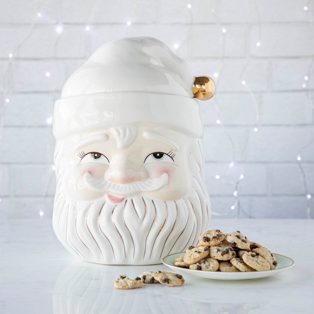 Papa Noel Cookie Jar with a plate of cookies next to it and string of lights in background