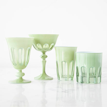 A set of SIR/MADAM Rialto Pale Sage Glasses and a bowl on a marble table.