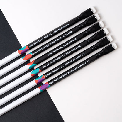 A group of Blackwing Volume 192- Tribute to John Lennon and Paul McCartney (Set of 12) colored pencils with a quote on them about songwriting by John Lennon and Paul McCartney.